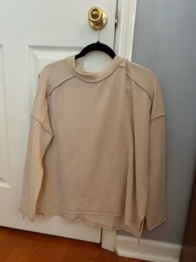 Women’s flowy, tan sweater